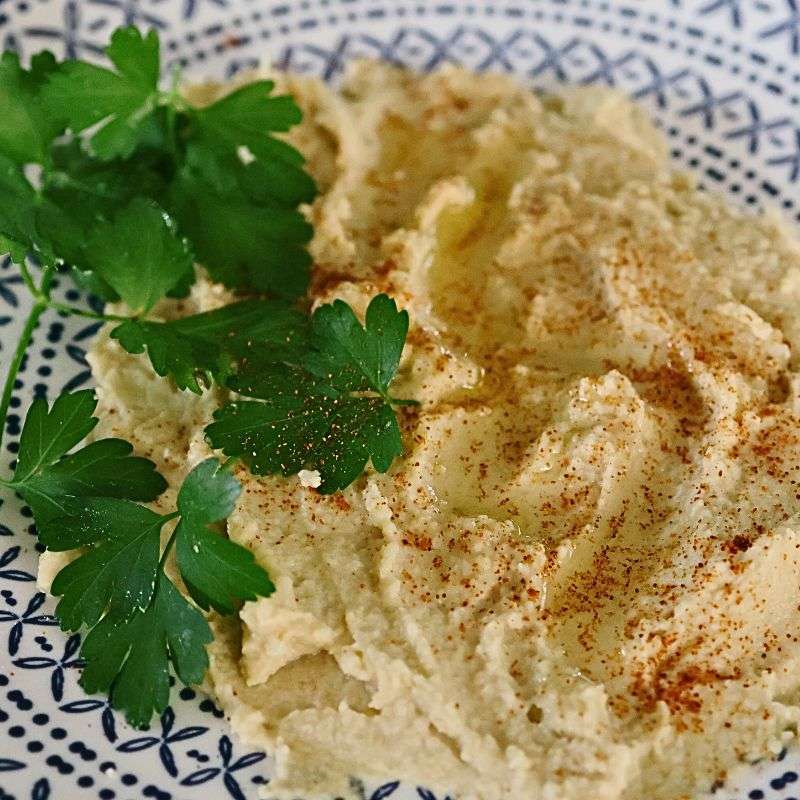 Sesame free tahini on blue and white patterned plated with parsley