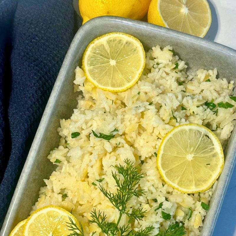 gluten free Greek lemon rice pilaf in grey stone baking dish