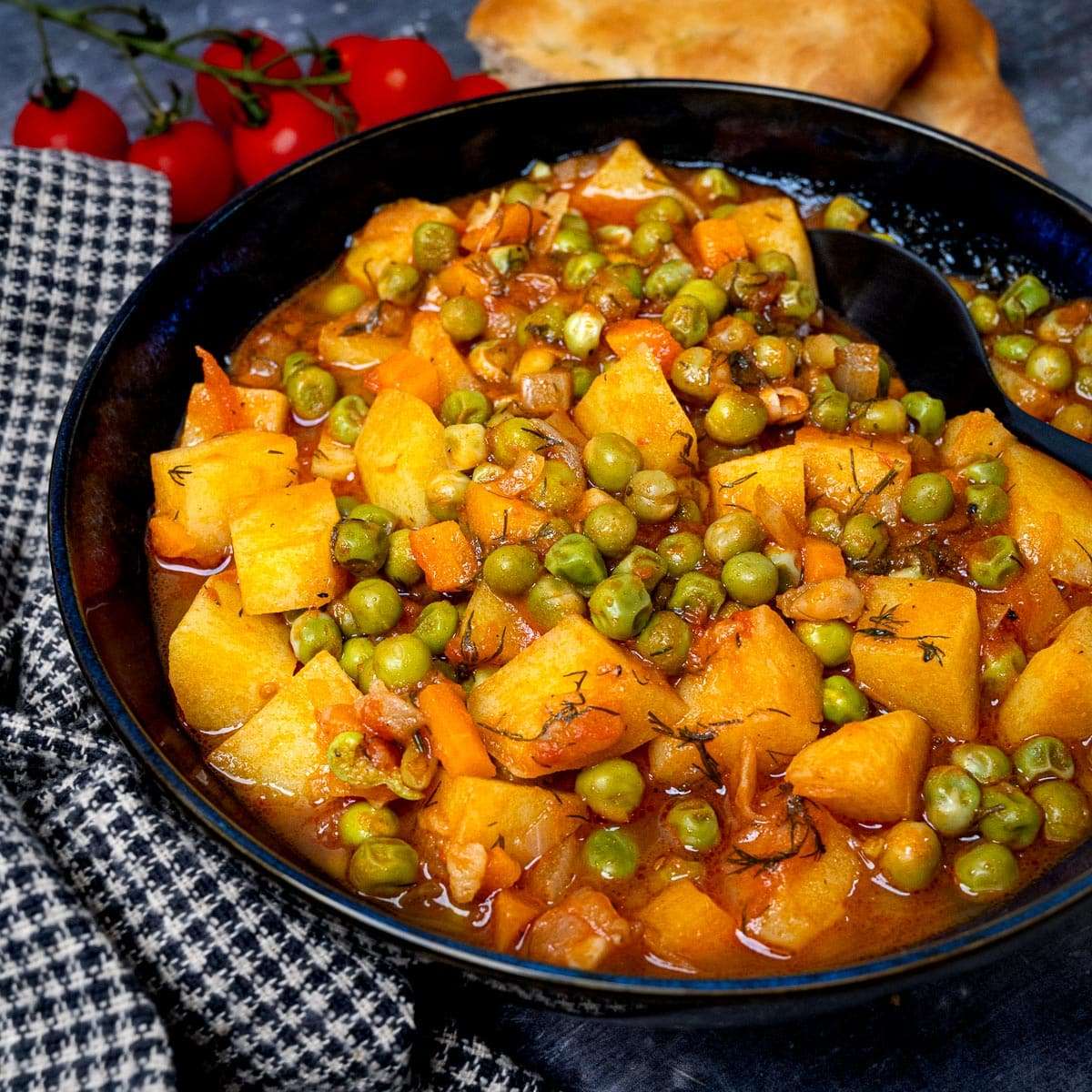 Greek peas stew with potatoes (Arakas Latheros) in black bowl
