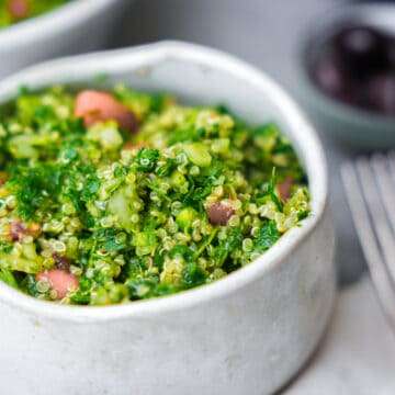 vegan tabbouleh salad in ceramic bowl with fork