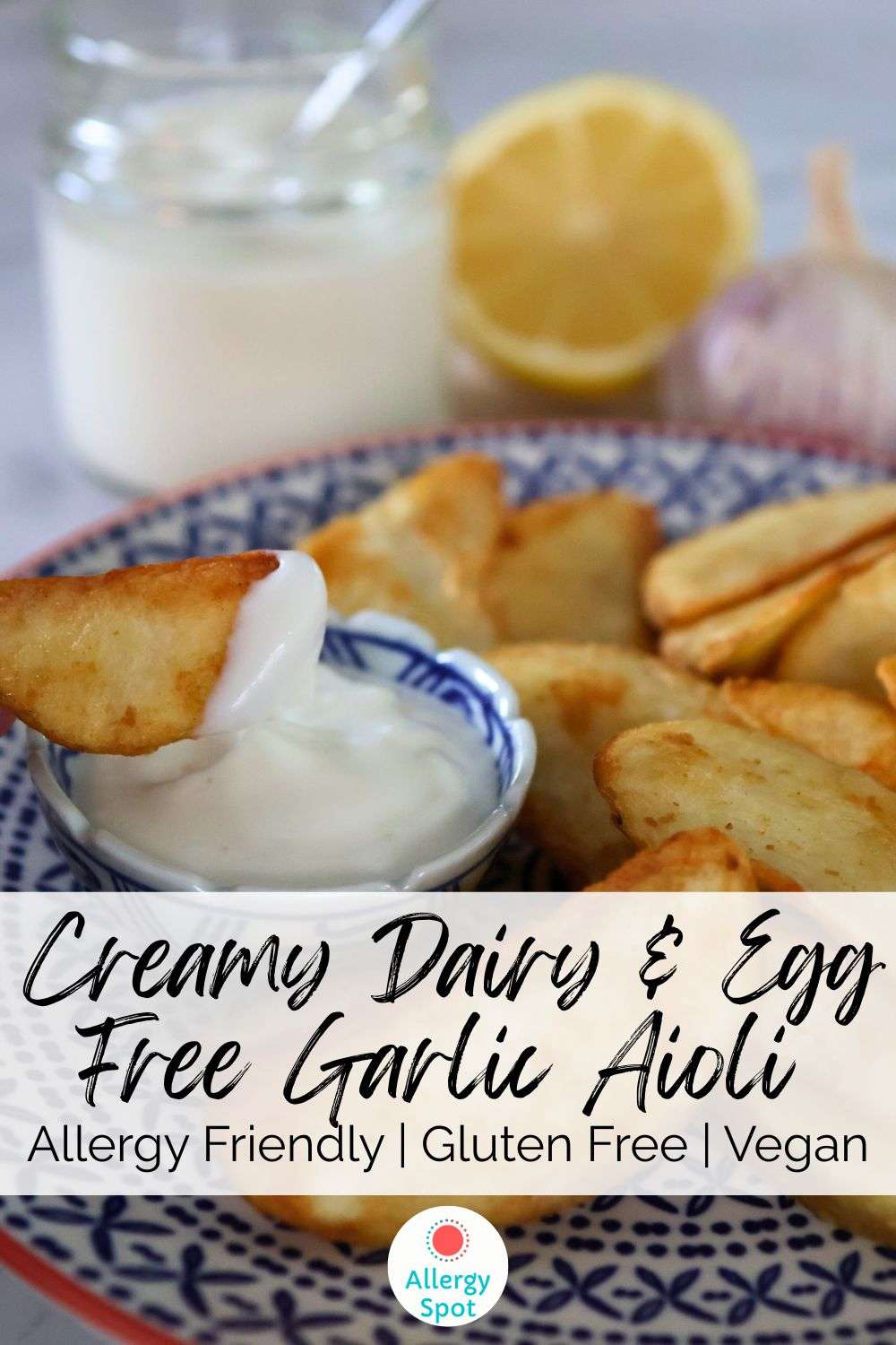 plate of wedges with dairy and egg free garlic aioli with jar of vegan aioli and lemon and garlic