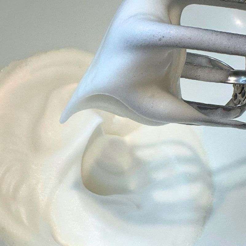 egg free meringues mixture whipped with electric mixer to make foamy peaks